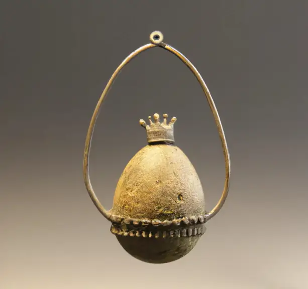 Iron age pendant of an egg champion